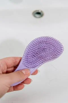 Hair loss problem when combing head, broken dry damaged hair on brush and sin Stock Photos