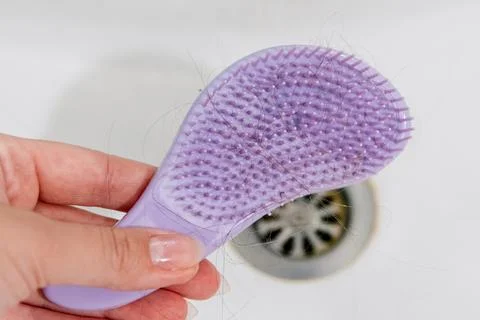 Hair loss problem when combing head, broken dry damaged hair on brush and sin Stock-Fotos