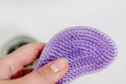 Hair loss problem when combing head, broken dry damaged hair on brush and sin Stock-Fotos