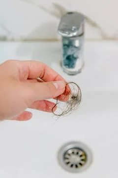 Hair loss problem when combing head, broken dry damaged hair on brush and sin Stock-Fotos