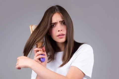Hair loss woman with a comb and problem hair. Hairloss and bald problems concept Stock Photos