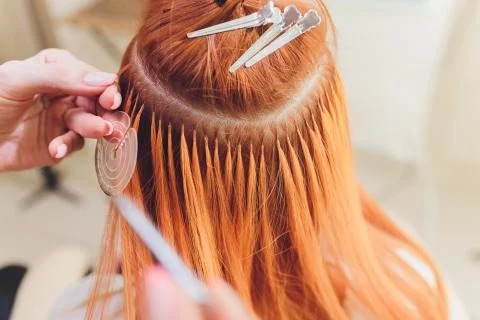 Hair salon, beauty spa. Procedure of hair extensions. Stock Photos