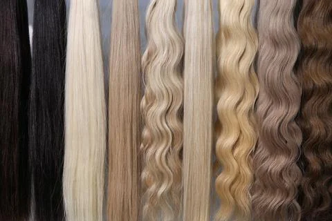 Hair samples for extensions from light to dark Stock Photos