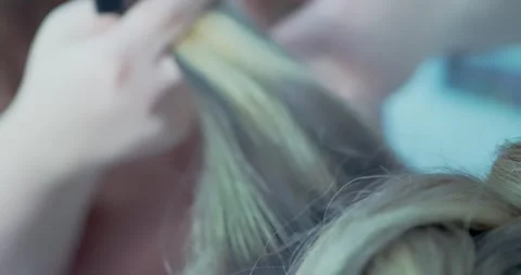 Hair Styling Process with Comb in Salon Stockbeeldmateriaal 323492528