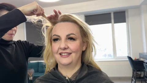 Hair styling session process of accelerating the action of hair dye using a Stock Footage 326775064