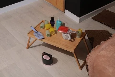 Hair styling tools and rollers arranged on a portable wooden tray table Fotos Stock