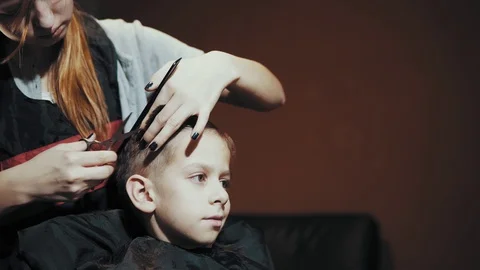 Haircut for boy scissors and comb at the hairdresser. Stock Footage 103383216