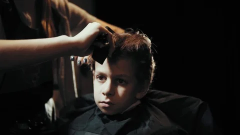 Haircut for boy scissors and comb at the hairdresser. Stock Footage 103383373