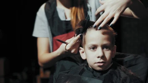 Haircut for boy scissors and comb at the hairdresser. Stock Footage 104658903