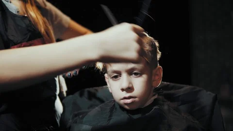 Haircut for boy scissors and comb at the hairdresser. Stock Footage 104659200