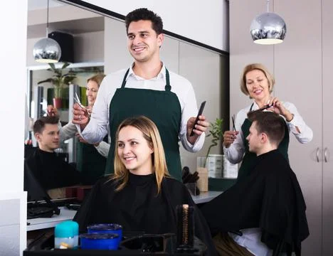 Hairdresser cuts hair at salon Stock Photos
