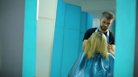 Hairdresser cutting hair Stock Footage
