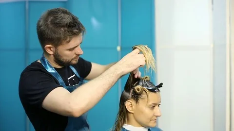 Hairdresser cutting hair of her customer Stock Footage