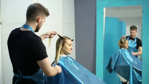 Hairdresser cutting hair of her customer Stock Footage