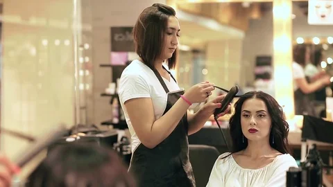 Hairdresser making curls medium shot Stock Footage