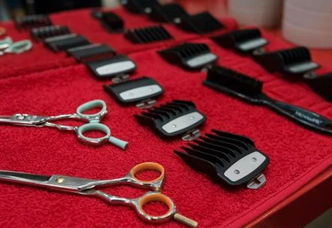 Hairdresser tools flat lay on red towel Stock Photos