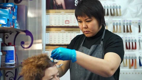 Hairdresser working with the client Stock Footage 87584095
