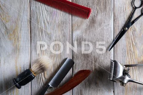 Hairdressing scissors vintage manual clipper comb brush dangerous razor are o Stock Photos