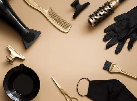 Hairdressing tools on a beige background. Frame of objects hair salon , sci.. Stock Photos