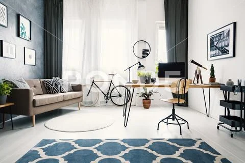 Hairpin table with retro telescope, mockup computer, fresh plants and lamp st Stock Photos