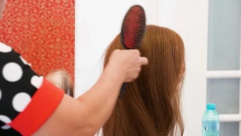 Hairstylist practicing on a doll Stock Footage 104904533