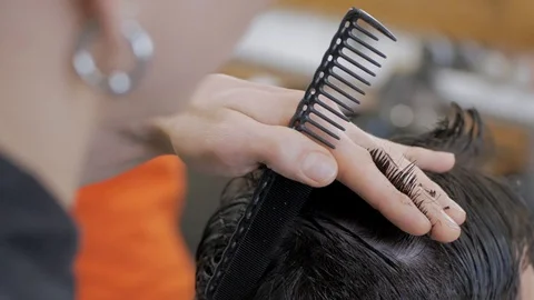 Hairstylist  at work Stock Footage 104876405