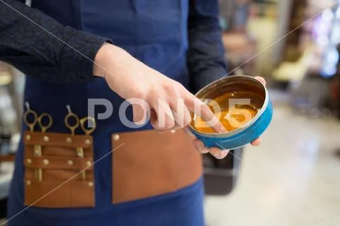 Hairstylist's hands with hair styling wax Stock Photos