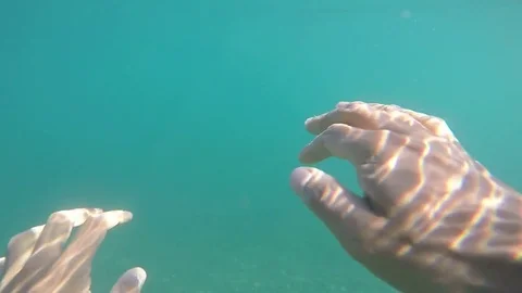 Hairy hands of a floating man under the water Stock Footage 81099592