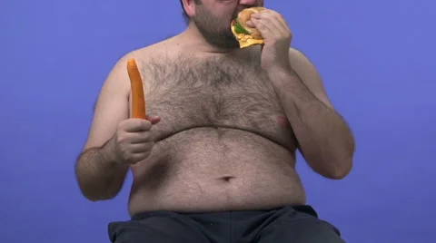 Hairy overweight man choosing between carrot and hamburger. Stock Footage 45926761