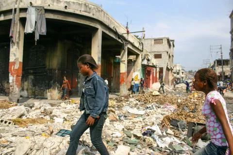 Haiti 2010 Earthquake Women Walking through Debris Stock Photos