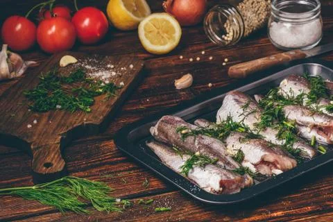 Hake carcasses on baking sheet Stock Photos