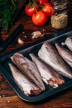 Hake carcasses on baking sheet Stock Photos