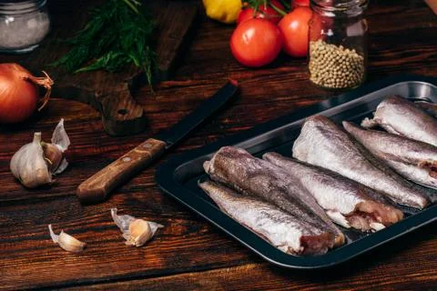 Hake carcasses on baking sheet Stock Photos