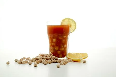 Halabsa chickpea soup with lime slice served in glass isolated on grey back.. Stock Photos