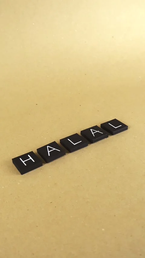 Halal word concept appearing with black tiles on brown paper background Stock Footage 346598097