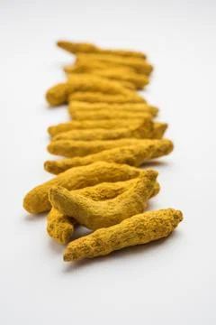 Haldi or Dried Turmeric Roots as a whole on white background Stock Photos
