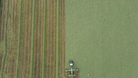 Half and half grass spreading with tractor Stock Footage 337462145