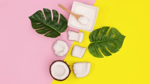 Half and slices of coconut move on yellow pink theme. Stop motion Stock Footage 147106356