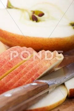 Half an apple, apple slices and knife Stock Photos