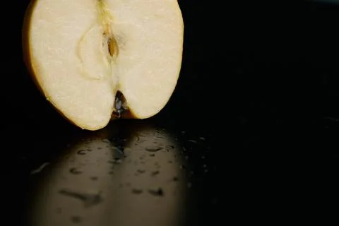 Half of apple on a black background Stock Photos