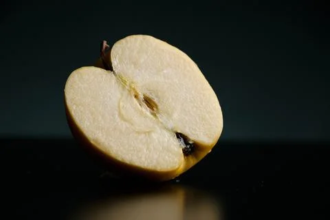 Half of apple on a black background Stock Photos
