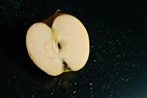 Half of apple on a black background Stock Photos