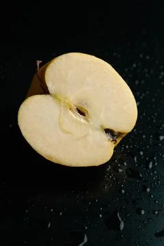 Half of apple on a black background Stock Photos