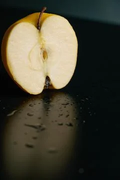 Half of apple on a black background Stock Photos