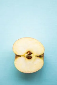 Half of apple on the blue background with copy space Stock Photos