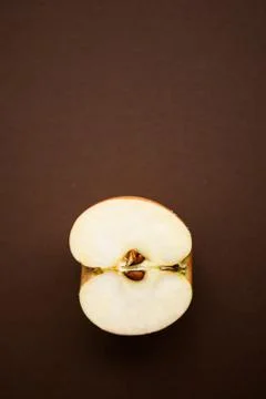 Half of apple on the chocolate background with copy space Stock Photos