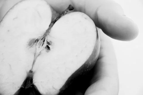 Half an apple in  hand man Stock Photos