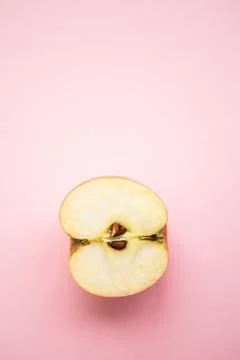Half of apple on the pink background with copy space Stock Photos