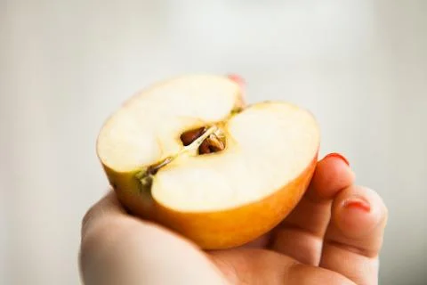 Half of the apple in somebody's hand Stock Photos