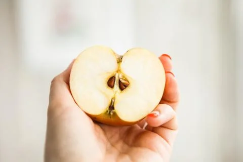 Half of the apple in somebody's hand Stock Photos